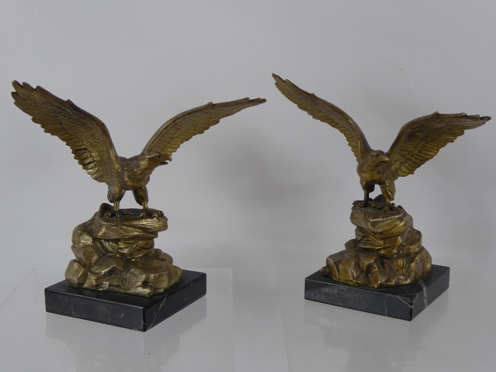 Two Brass Figures of Eagles, perched on rocks presented on a marble base, approx 20 cms high.