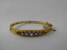 An Antique 18 ct Yellow Gold and Aquamarine Bangle, the bangle set with 9 graduated stones 2 to 5