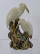 A Porcelain Figure of a Pair of Storks, resting upon a tree stump, approx 28 cms high.