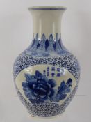 An Oriental Blue and White Onion Shaped Vase, with decorative pattern and peony flower, marks to