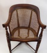 A Child's Oak and Wicker Chair, with cross stretchers and swept arms.