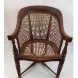 A Child's Oak and Wicker Chair, with cross stretchers and swept arms.