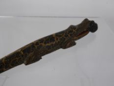 A Wood Carved Letter Opener, depicting a crocodile swallowing a man, approx 30 cms together with a