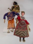 Two Chinese Opera Dolls, with moulded and painted heads and dressed in embroidered silk costume