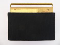 A Volupte U.S.A., Brass Compact, in original pouch.