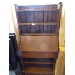 An Arts & Crafts Style Book Case Desk. The desk having three shelves with drop-down writing slope