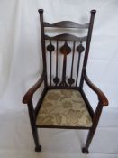 An Arts & Crafts Arm Chair, upholstered seat, carved back.