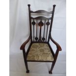 An Arts & Crafts Arm Chair, upholstered seat, carved back.