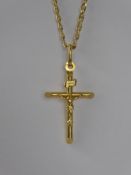An 18 ct Yellow Gold Crucifix Pendant and Chain, approx 6.2 gms