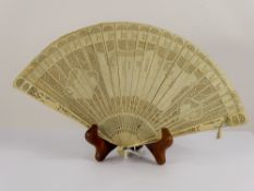 A Lady's 19th Century Delicate Ivory Brisé Fan, carved with classical figures to central