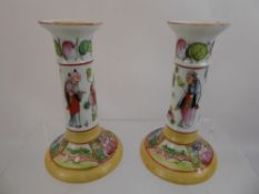 A Pair of Hand Painted Chinese Candlesticks, depicting a figure and floral decoration, approx 16 cms
