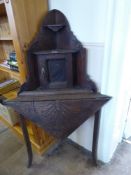 A Mahogany Carved Corner Table, with small cupboard atop and two shelves, approx 53 x 53 x 130