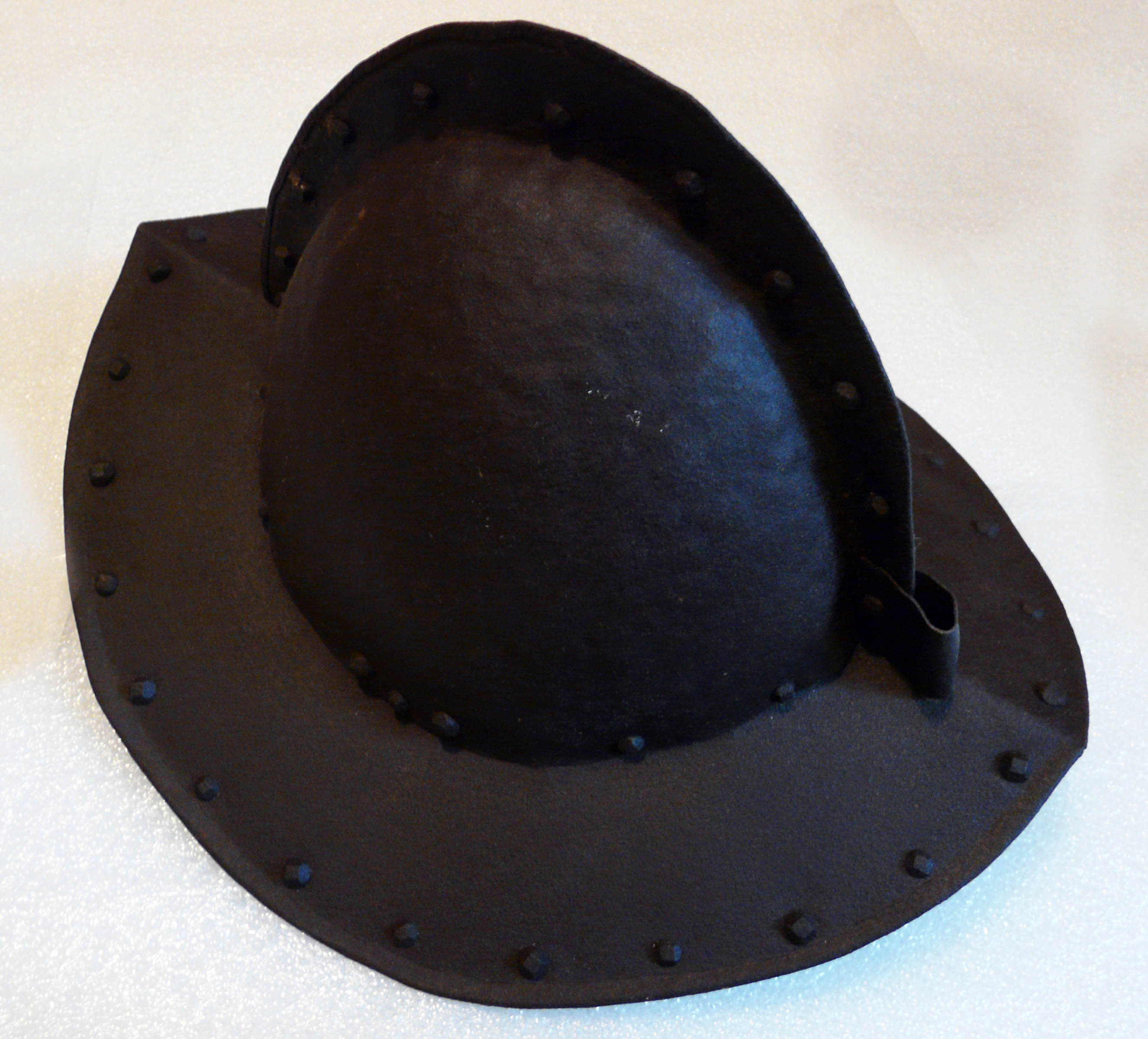 An Antique Comb Morian Helmet, the continental helmet is made of steel and has hand forged rivets.