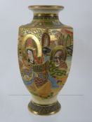 An Oriental Vase, depicting the faces of a lady and two gentlemen, raised pattern with bands of gold