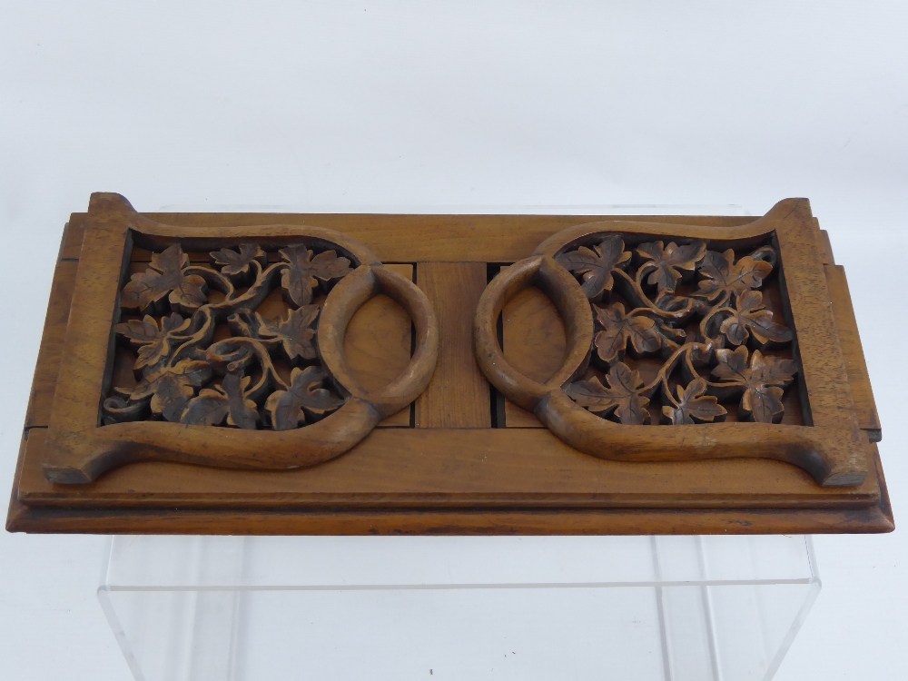 A Victorian Walnut and Mahogany Book Slide, the book slide having carved ends in the form of vine