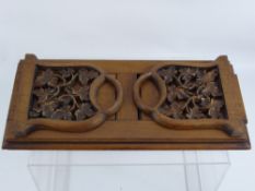 A Victorian Walnut and Mahogany Book Slide, the book slide having carved ends in the form of vine