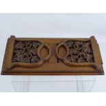 A Victorian Walnut and Mahogany Book Slide, the book slide having carved ends in the form of vine