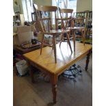 A Pine Kitchen Table, approx 150 x 90 cms, on turned legs together with four pine Reach chairs and