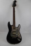 A Squire Stratocaster Black Electric Guitar, approx 100 cms.