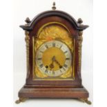 A Mahogany-Carved Bracket Clock, the clock having a silvered chapter ring with applied cherubs and