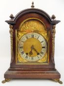 A Mahogany-Carved Bracket Clock, the clock having a silvered chapter ring with applied cherubs and