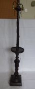 A Stained Oak Twin Lamp Stand, with decorative carving to centre column, aprox 170 cms high.