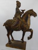 An Antique Chinese Tang Dynasty Style Gilt Wood Horse, the rider astride with a bird on his hand,