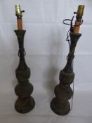 Two Bronze Effect Oriental Style Lamp Stands, with Buddhist symbolism, approx 68 cms.