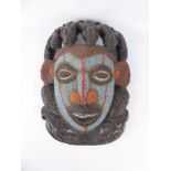 An Antique West African Fertility Mask, the mask intricately worked with black, white, blue and