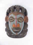 An Antique West African Fertility Mask, the mask intricately worked with black, white, blue and