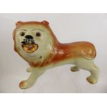 A Staffordshire Mantel Figure, in the form of lion with glass eyes, approx 39 cms in length.
