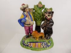 A Staffordshire Style Figural Group, depicting a dancing bear and savoyard, with lion in the