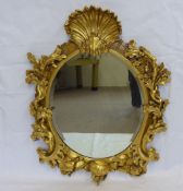 A Gilt-Framed Over Mantel Mirror, the frame carved with oak leaves and acorns, the mirror with