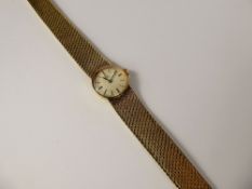 A Lady's 9ct Gold Omega Wrist Watch, the watch having a silvered face with baton numerals,