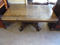 An Oak Coffee Table, with ornate central column on splayed feet, approx 116 x 67 x 49 cms.