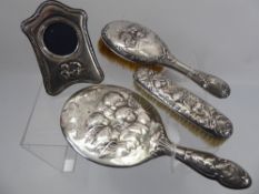 A Silver Dressing Table Set, comprising hair brush, hand mirror, clothes brush, the group with