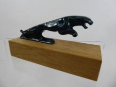 A Racing Green Jaguar Car Mascot, raised on a rectangular base, approx 15 x 5 x 3 cms together