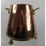 A Twin Handled Arts & Crafts Copper Pot, raised on three bun feet, approx 25 cms dia at base.