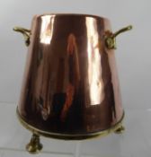 A Twin Handled Arts & Crafts Copper Pot, raised on three bun feet, approx 25 cms dia at base.