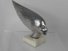 A 'Spirit of the Wind' Chrome Plated Car Mascot, on a white marble base.