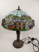 A Tiffany-Style Table Lamp, with cottages in relief, approx 58 cms