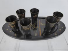 A Vintage Ebonised Japanese Sake Set, on oval tray.