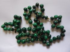 Two Malachite Necklaces, beads on the first measure approx 10 - 16 mm, the second approx 44 - 64