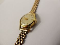 A Lady's Vintage 18 ct Yellow Gold Juvena Wrist Watch, on a 9ct gold bracelet, the watch having a