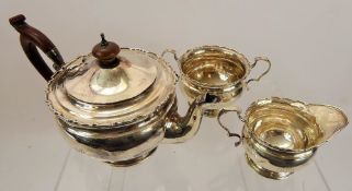 A Silver Tea Trio, comprising teapot, milk jug, sugar bowl, Birmingham hallmark, mm Adie Bros Ltd,