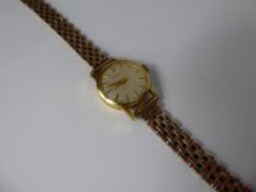 A Lady's Vintage Gold Plated Omega Cocktail Watch, having a champagne face with baton numerals. (