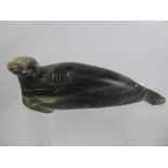 An Early 20th Century Inuit Soapstone Carving, depicting a Walrus, approx 27 cms, signed