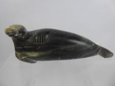 An Early 20th Century Inuit Soapstone Carving, depicting a Walrus, approx 27 cms, signed