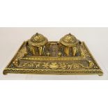 A Brass Ink Stand, the stand having two lidded wells and decorative floral pattern to base, approx
