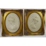 A Pair of Marble Plaques, in high relief of ladies in profile, the verso inset with a medallion
